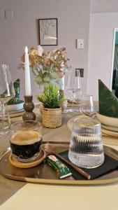 a table with a candle and a plate with a cup of coffee at The Boutique Suite - Schaanwald in Schaanwald