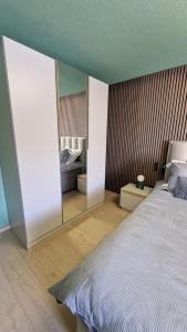 a bedroom with a large bed and a mirror at The Boutique Suite - Schaanwald in Schaanwald