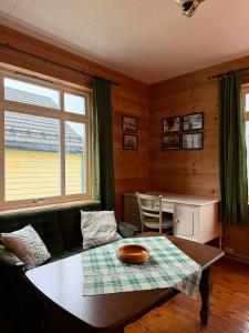 a living room with a couch and a table at Davik Fjordparadis in Bakken +49 photos