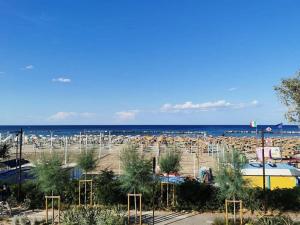 a beach with a lot of umbrellas and the ocean at Hotel Mirage in Rimini