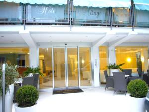 a building with a table and chairs in front of it at Hotel Mirage in Rimini