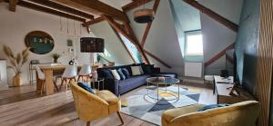 a living room with a blue couch and a table at Duplex Centre - Le Marché in Obernai