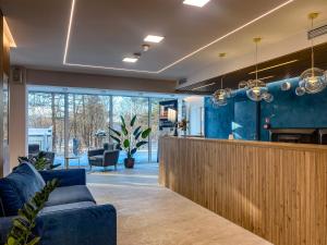 a lobby with a bar with blue furniture at Szum Bałtyku in Jastrzębia Góra +41 photos