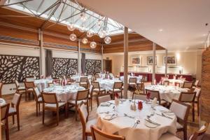 a dining room with white tables and chairs at Rewley House University of Oxford in Oxford