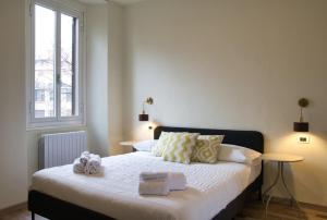 a bedroom with a bed with towels on it at Cozy home away in Lecco
