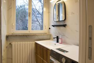 a bathroom with a sink and a window at Cozy home away in Lecco +20 photos