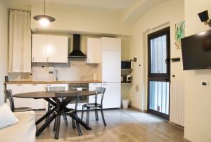 a kitchen and dining room with a table and chairs at Cozy home away in Lecco