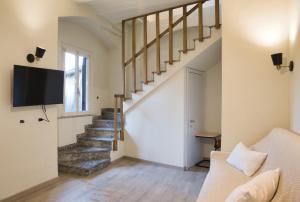 a living room with a staircase and a couch at Cozy home away in Lecco