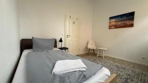 a bedroom with a bed in a white room at Das MONTI - Superior in Stendal