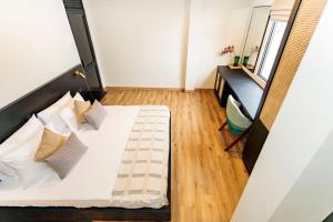 a small bedroom with a bed and a desk at Altitude Ambuluwawa in Gampola +31 photos