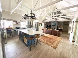 a kitchen and living room with a island in a room at Misty Moon in Malgas