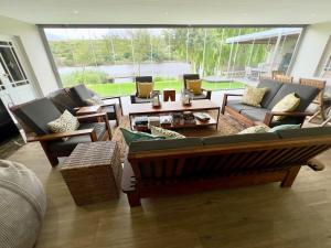 a living room with a couch and chairs and a table at Misty Moon in Malgas