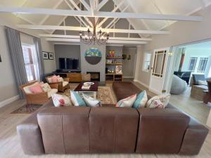 a living room with a brown leather couch at Misty Moon in Malgas