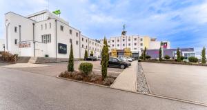 a car parked in a parking lot next to a building at PLAZA INN Bad Rappenau in Bad Rappenau