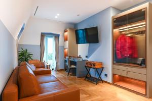 a living room with a couch and a desk at Hotel Astoria in Rapallo