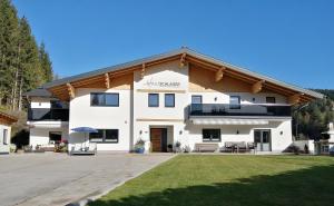 a large white building with a roof at Haus Schlager "dasAppartement" in Annaberg im Lammertal