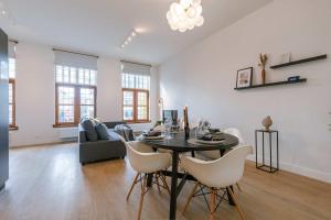 a living room with a table and chairs at Apartment near Antwerp Cathedral in Antwerp