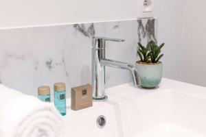 a bathroom counter with a sink and a faucet at Apartment near Antwerp Cathedral in Antwerp