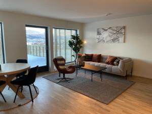 a living room with a couch and a table at Hotell Sjyen in Nesna