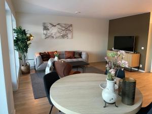 a living room with a table and a couch at Hotell Sjyen in Nesna
