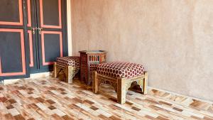 a pair of chairs sitting next to a wall at Dar Soulaimane in Marrakesh