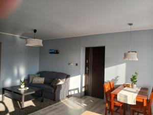 a living room with a couch and a table at Duży Apartament 75m2 in Wągrowiec