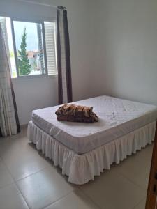 a bed in a white room with a mattress sidx sidx sidx at Casa Lovato in Arroio do Sal +6 photos