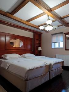 a bedroom with a large bed with a wooden headboard at Salaš 1860 - Palić in Palić