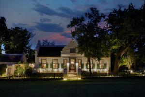 a white house with lights in front of it at Blaauwklippen Manor by NEWMARK in Stellenbosch +73 photos