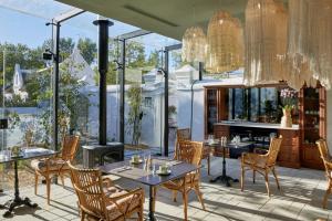 a patio with tables and chairs and a fireplace at Blaauwklippen Manor by NEWMARK in Stellenbosch