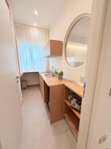 a bathroom with a sink and a mirror at Ab aparthotel in Gizzeria +106 photos
