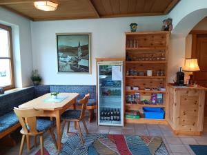 a dining room with a table and a refrigerator at Pension Tirol in Nauders