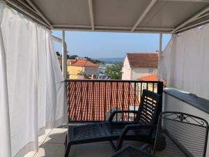 a balcony with two chairs and a view at Goga in Selce