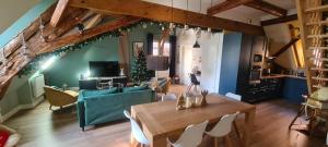 a living room with a table and a couch at Duplex Centre - Le Marché in Obernai