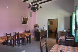 a dining room with tables and chairs and a chandelier at Inti Raymi in Maimará