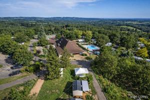 an aerial view of a house with a pool and trees at Camping O'Aka in Leyme