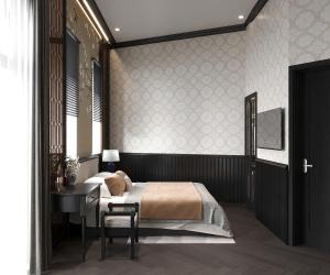 a bedroom with a bed and a table and a desk at Gold Villa in Trai Mat