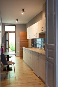 a kitchen with a table and a dining room at Csaba Vendégház in Izsák