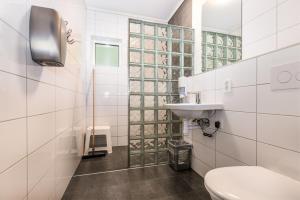 a bathroom with a toilet and a sink at Flåm Hostel & Cabins in Flåm +63 photos