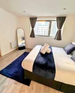 a bedroom with a large bed and a large mirror at Waters View in Edinburgh
