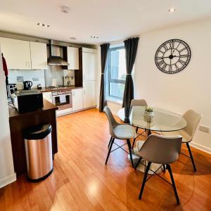 a kitchen and dining room with a table and chairs at Waters View in Edinburgh