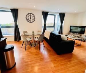 a living room with a couch and a table at Waters View in Edinburgh