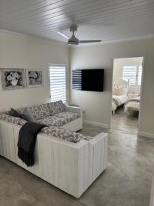 a living room with a couch and a flat screen tv at Seascape in Dwarskersbos +11 photos