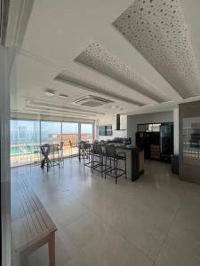 a large living room with chairs and a table at Nas Nuvens em Itaparica in Vila Velha