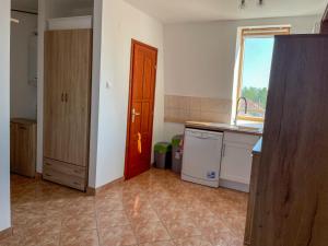 an empty kitchen with a sink and a window at Hársfa Central Apartment in Mórahalom