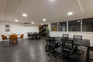a meeting room with tables and chairs in a building at Nas Nuvens em Itaparica in Vila Velha +44 photos