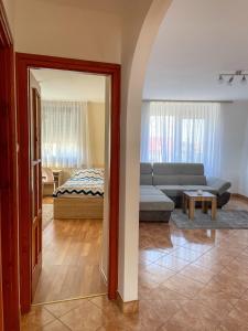 a living room with a couch and a bed at Hársfa Central Apartment in Mórahalom