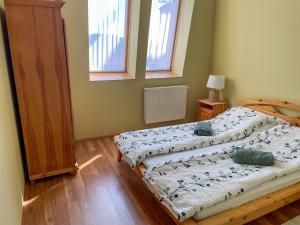 a bedroom with a bed and a window at Hársfa Central Apartment in Mórahalom