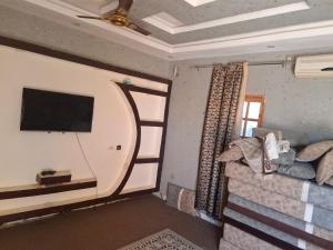 a living room with a couch and a flat screen tv at ramadan in Tombouctou