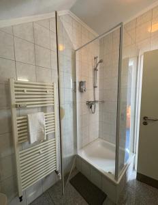 a bathroom with a shower and a bath tub at Nassauer Hof Wiesbaden-Schierstein in Wiesbaden +17 photos